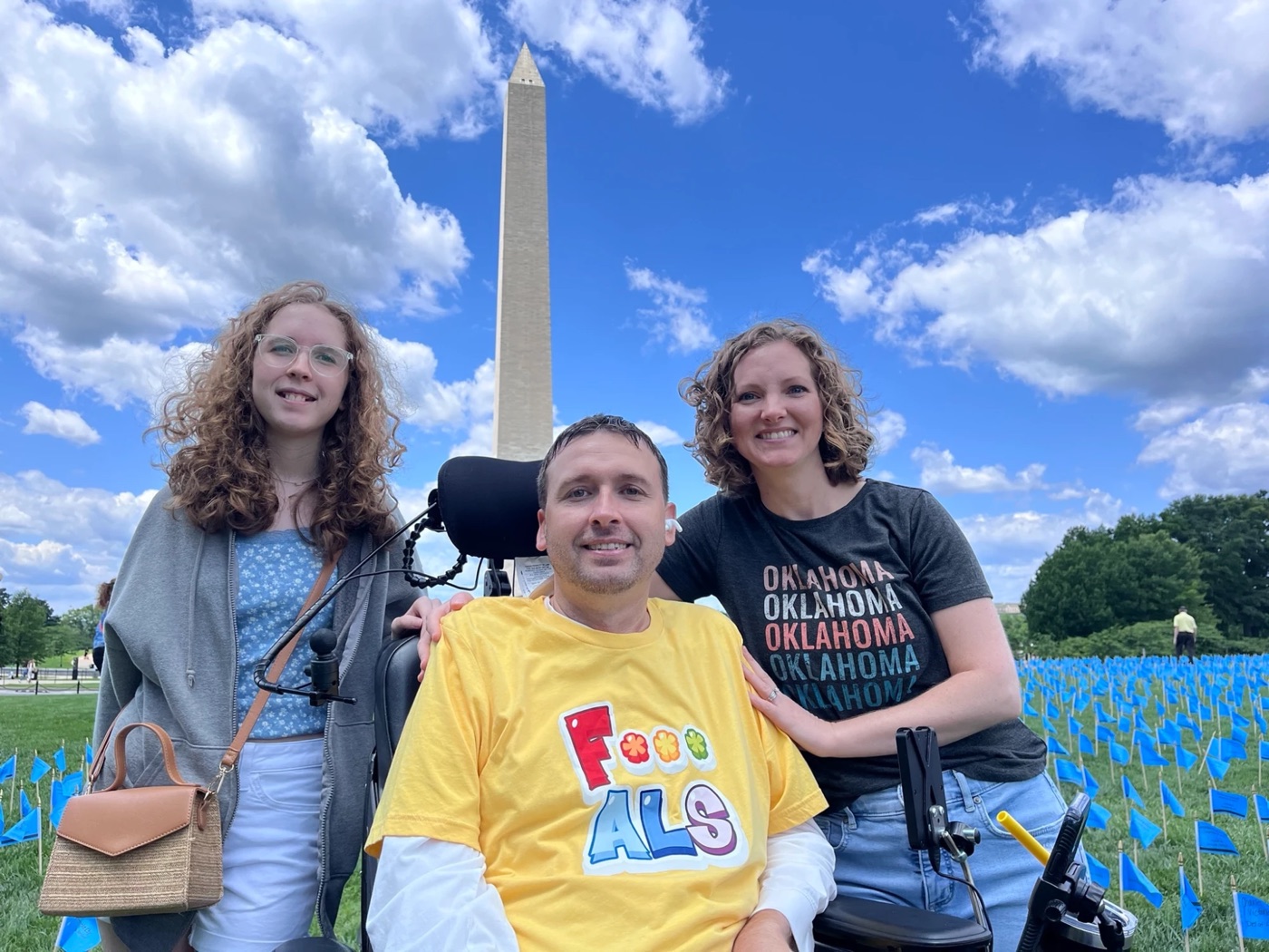 Michael Wilson in his power wheelchair with two others in front of the Washington Monument